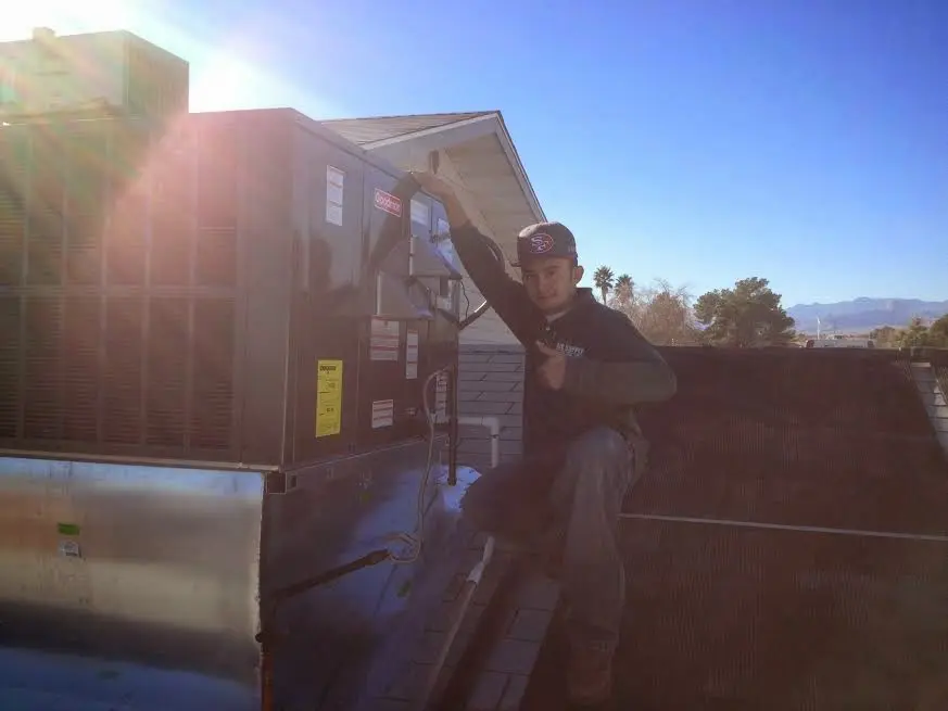 HVAC technician performing Heat Pump Repair on a rooftop unit in Eastern Goleta Valley